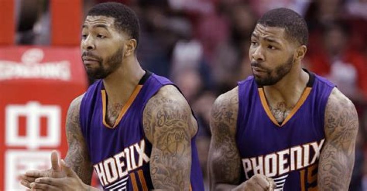 Do the Morris twins have identical tattoos?